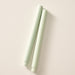 Two sage green colored pillar candles with ribbed bases, laying flat on a white background.
