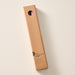 A tall, narrow cardboard box with a circular window display cutout at the top showing two blackberry candles inside, photographed on a clean off-white background. The box has printed text near the bottom including the brand name 'Ten Thousand Villages'.